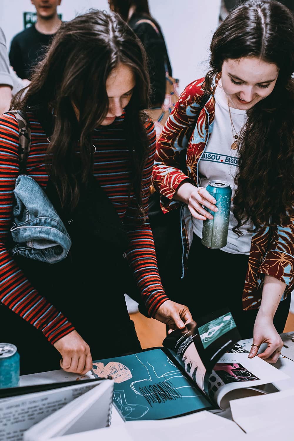 Two young girls reading Siege Magazine